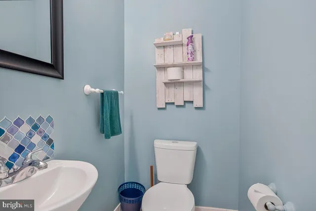 a white toilet sitting next to a bathroom sink