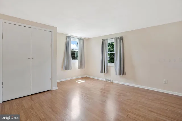 a view of an empty room and wooden floor