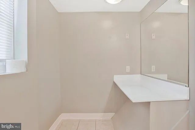 a view of a room with wooden floor and window