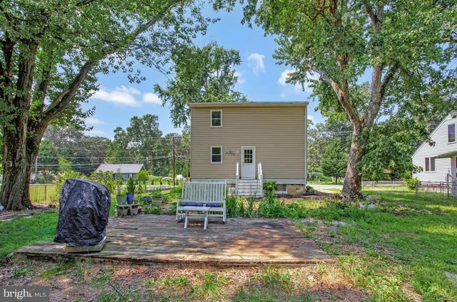 a view of backyard with house and outdoor seating