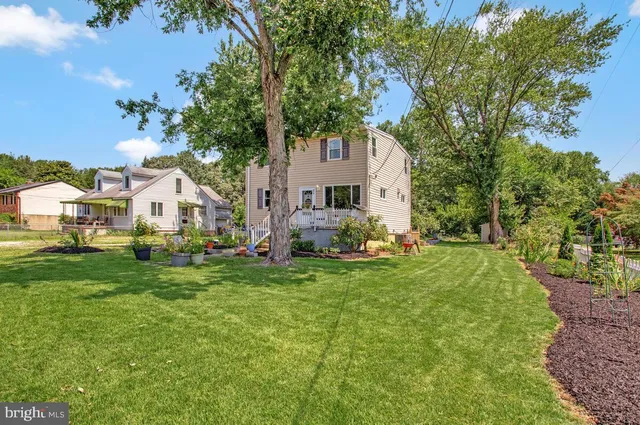 a front view of house with yard and trees