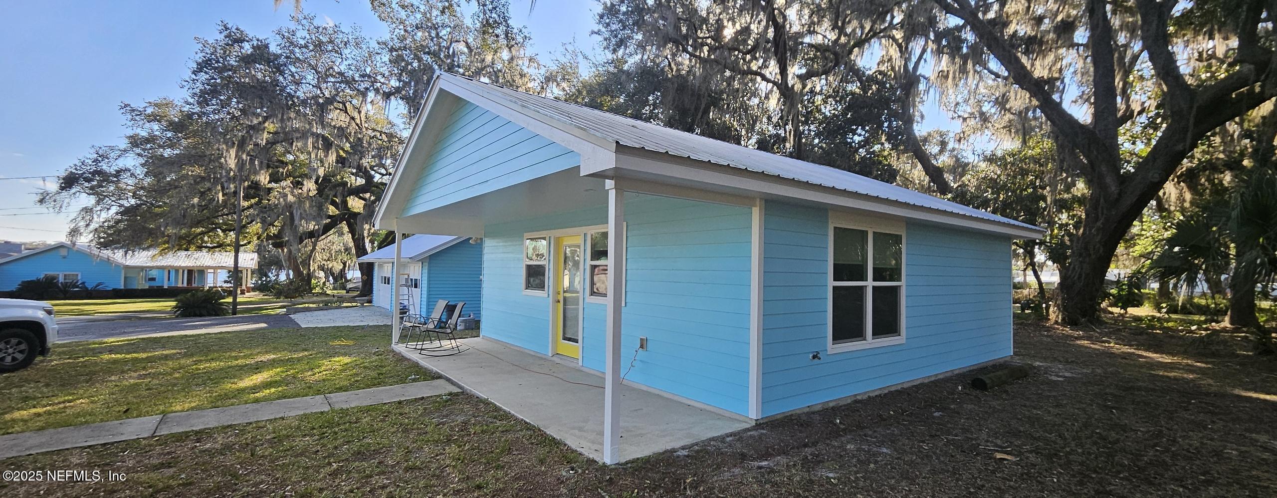 1521 County Road 309, Unit 1 Georgetown, FL 32139 - Photo 1 of 10 a view of a house with a yard tree and a large tree