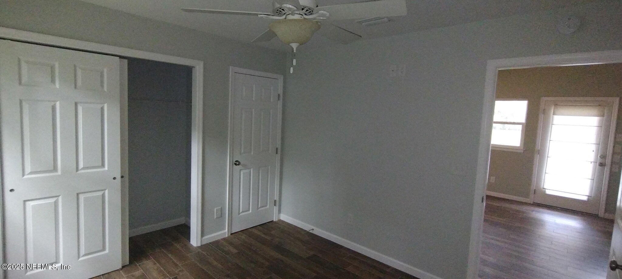 1521 County Road 309, Unit 1 Georgetown, FL 32139 - Photo 8 of 10 an empty room with wooden floor closet and windows