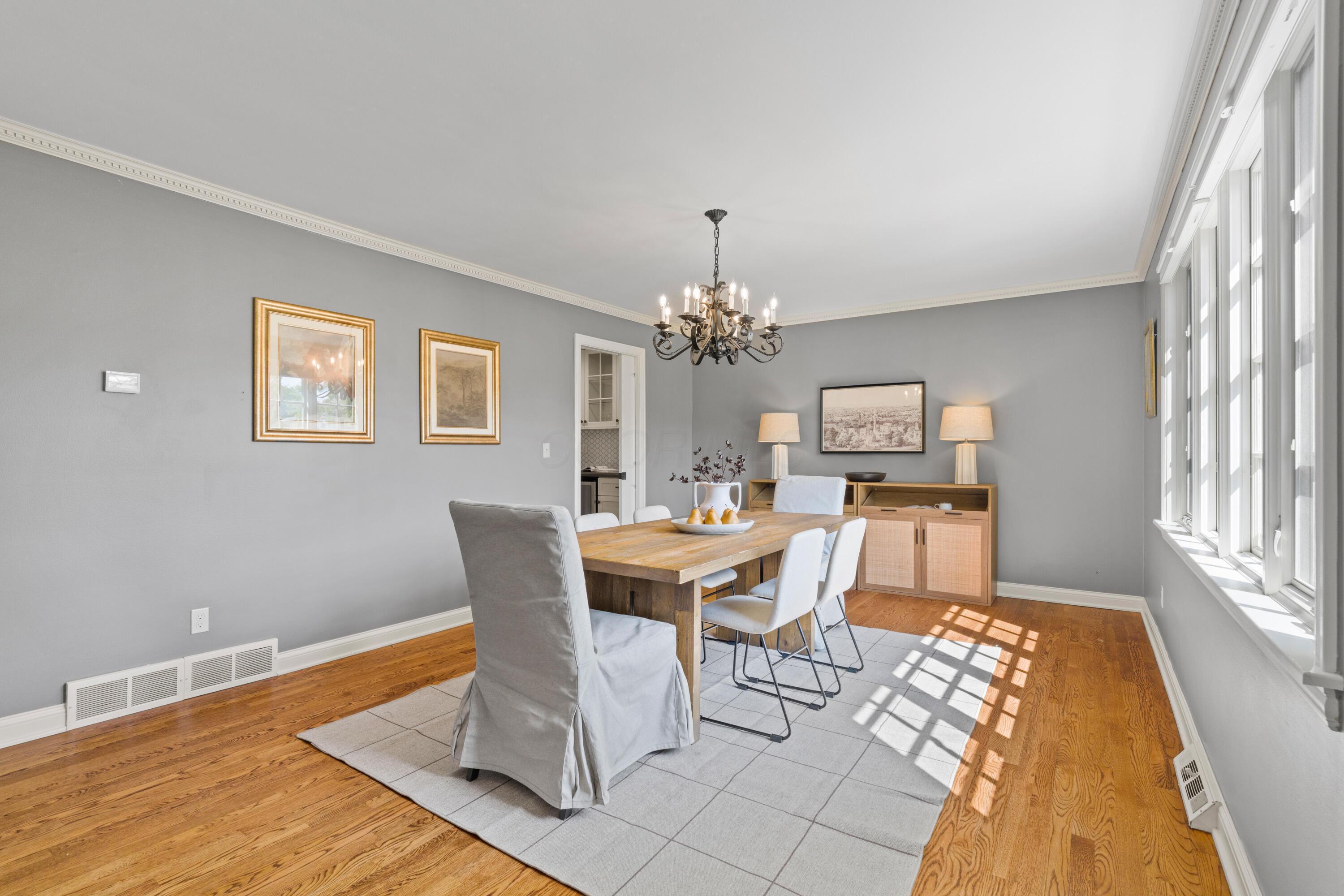 1326 Windham Road Columbus, OH 43220 - Photo 5 of 67 Currently shown as a Dining Room but could be used an office/den or Living Room! Dining Room with stunning Pella windows, showcasing the beautiful front landscaping. Dentil crown molding and pocket door leading to the Butler's pantry