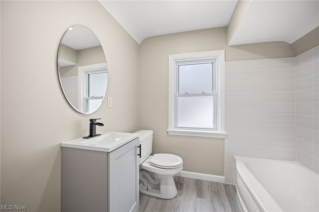 4892 Corliss Road Cleveland, OH 44124 - Photo 29 of 35 Full bathroom featuring hardwood / wood-style flooring, vanity, a wealth of natural light, and toilet