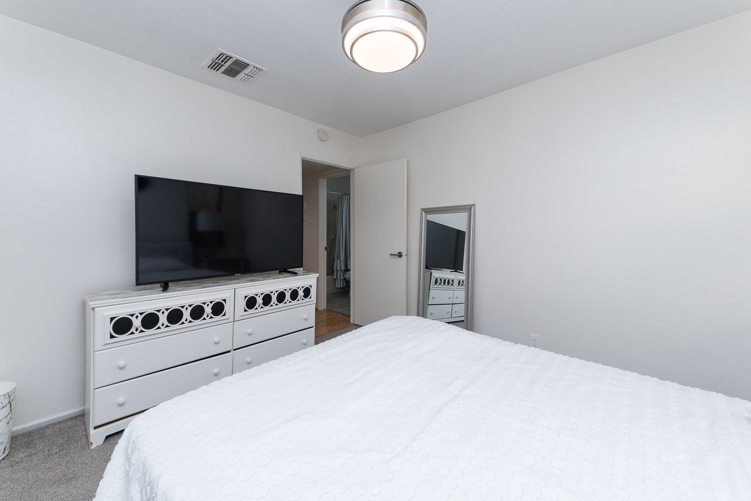 218 Washington Way Ridgecrest, CA 93555 - Photo 13 of 34 a bedroom with a bed and a flat screen tv