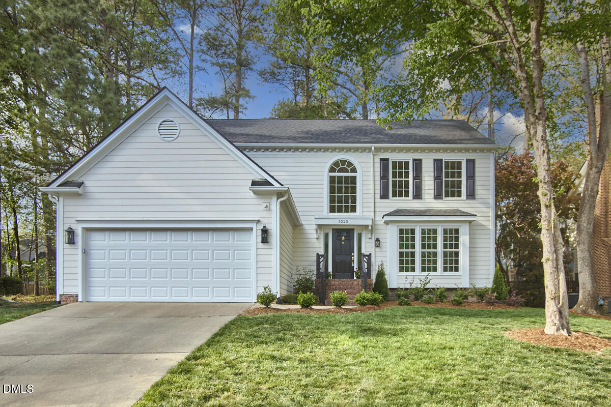 5220 Oakbrook Drive Durham, NC 27713 - Photo 1 of 38 a front view of a house with a yard