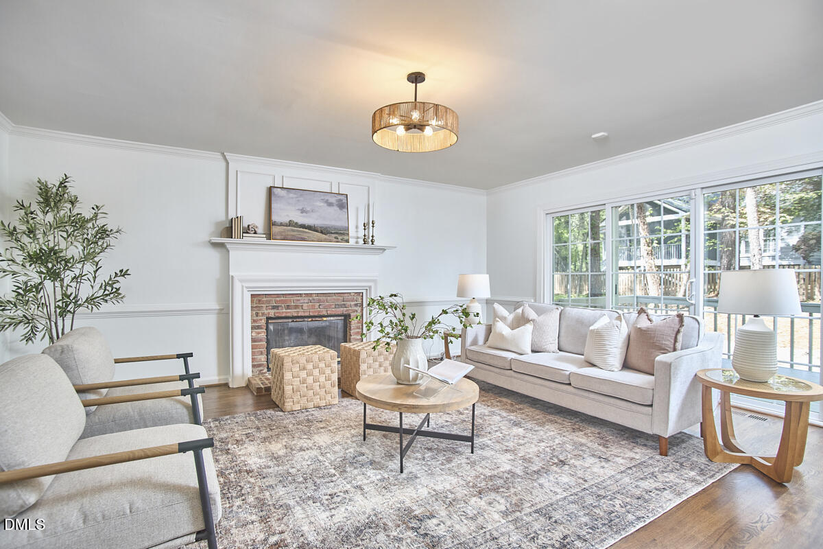 5220 Oakbrook Drive Durham, NC 27713 - Photo 16 of 38 a living room with furniture a fireplace and a table