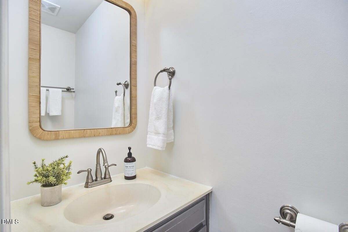 5220 Oakbrook Drive Durham, NC 27713 - Photo 18 of 38 a bathroom with a sink and a mirror
