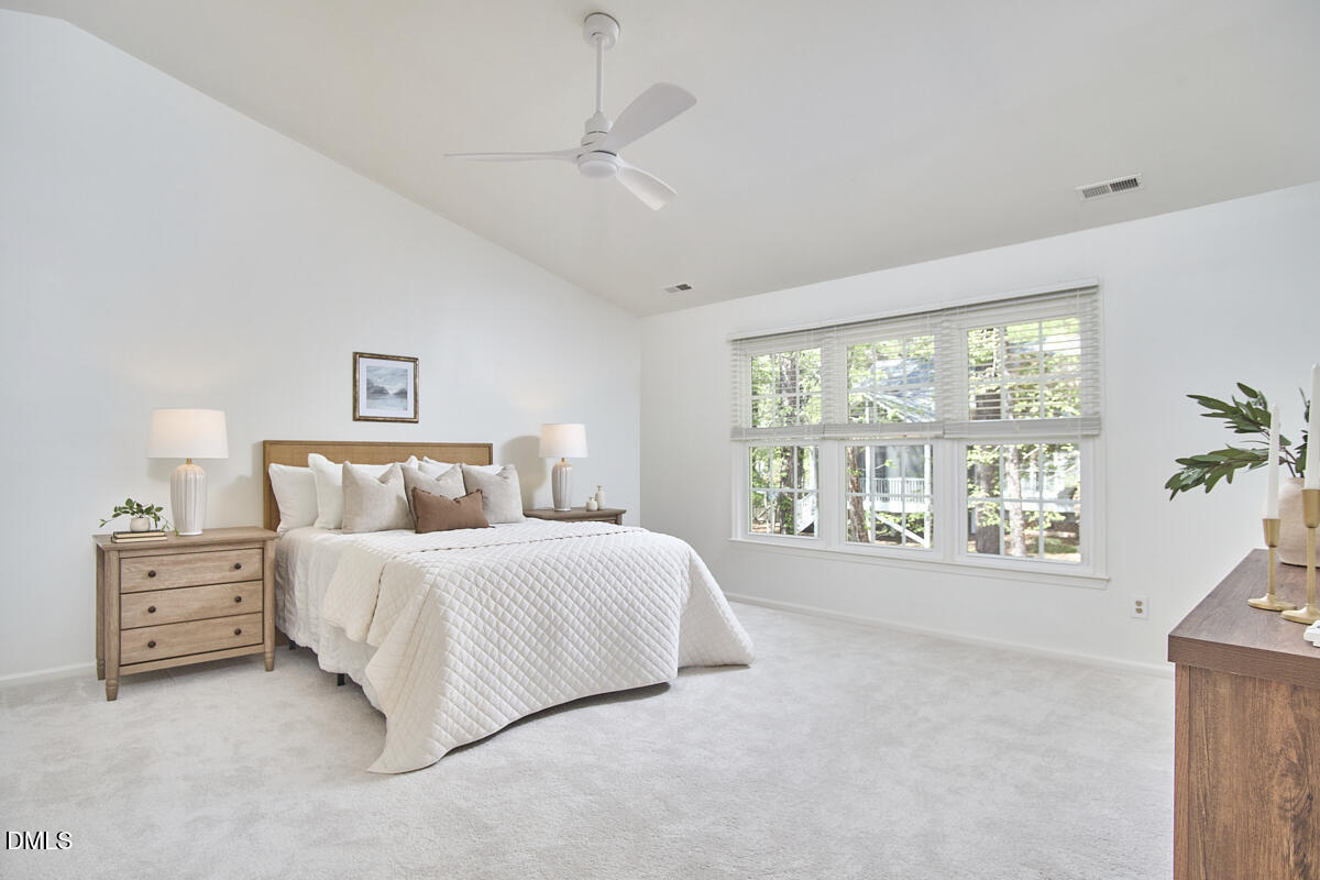 5220 Oakbrook Drive Durham, NC 27713 - Photo 19 of 38 a spacious bedroom with a large bed and a window