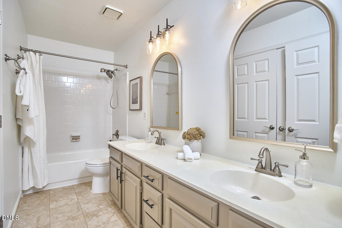 5220 Oakbrook Drive Durham, NC 27713 - Photo 25 of 38 a bathroom with a double vanity sink mirror and toilet
