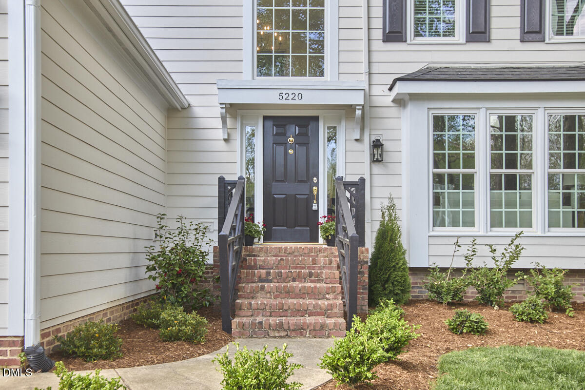 5220 Oakbrook Drive Durham, NC 27713 - Photo 3 of 38 a front view of a house with a yard