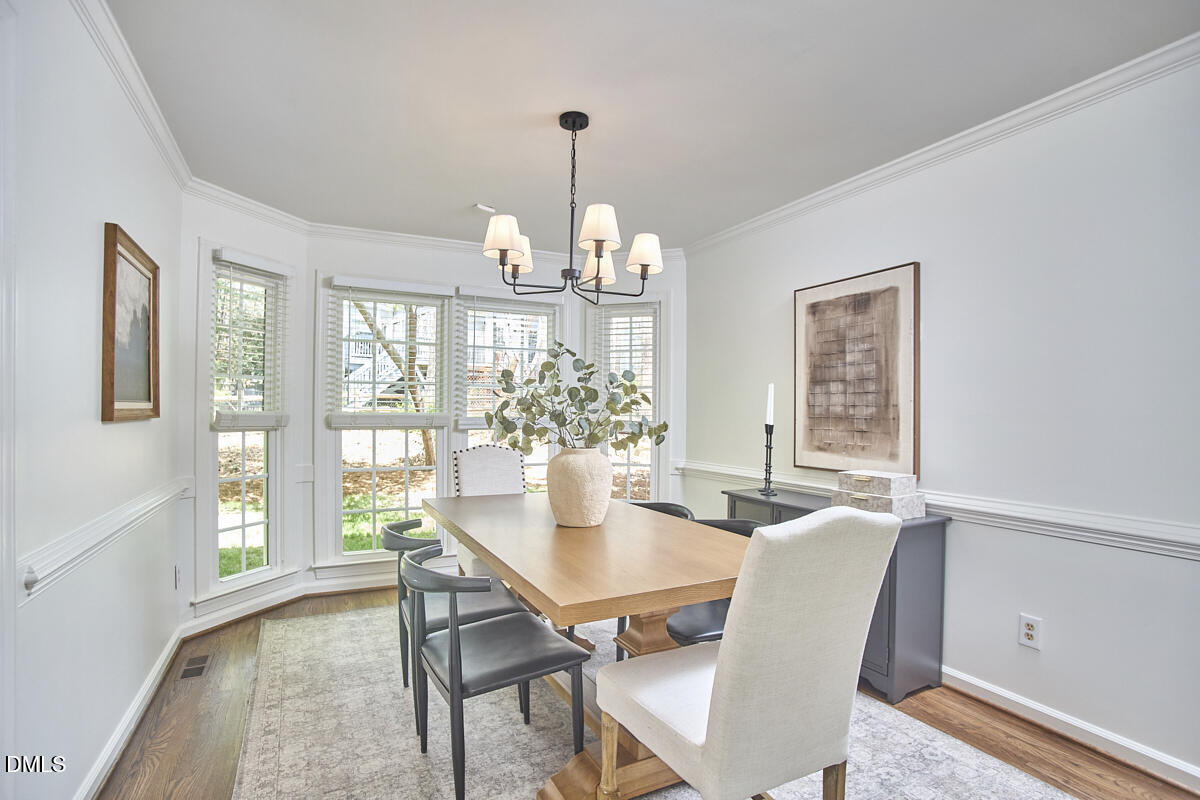 5220 Oakbrook Drive Durham, NC 27713 - Photo 7 of 38 a view of a dining room with furniture window and wooden floor
