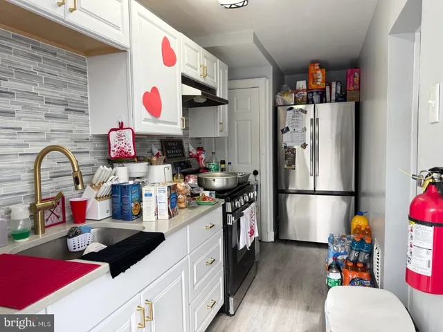 a kitchen with refrigerator and cabinets
