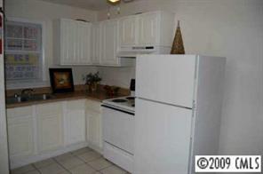4218 Castleton Road Charlotte, NC 28211 - Photo 3 of 3 a kitchen with a white cabinets and white appliances