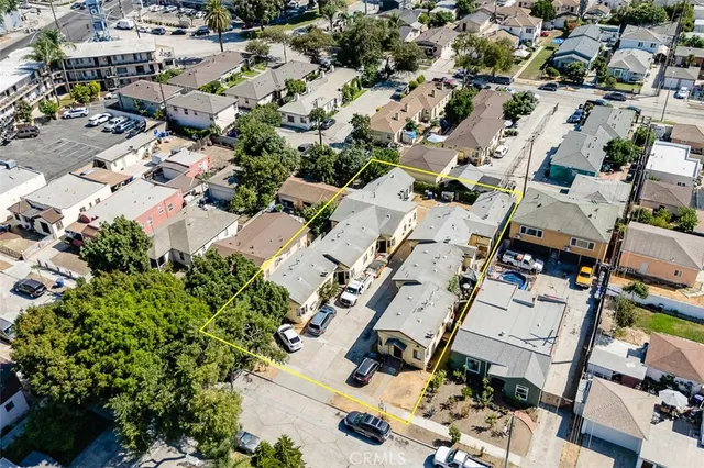 an aerial view of multiple houses with yard