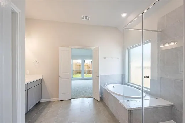 a bathroom with a bathtub and a shower