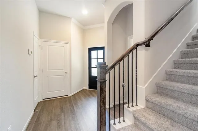 a view of entryway with wooden floor and stairs