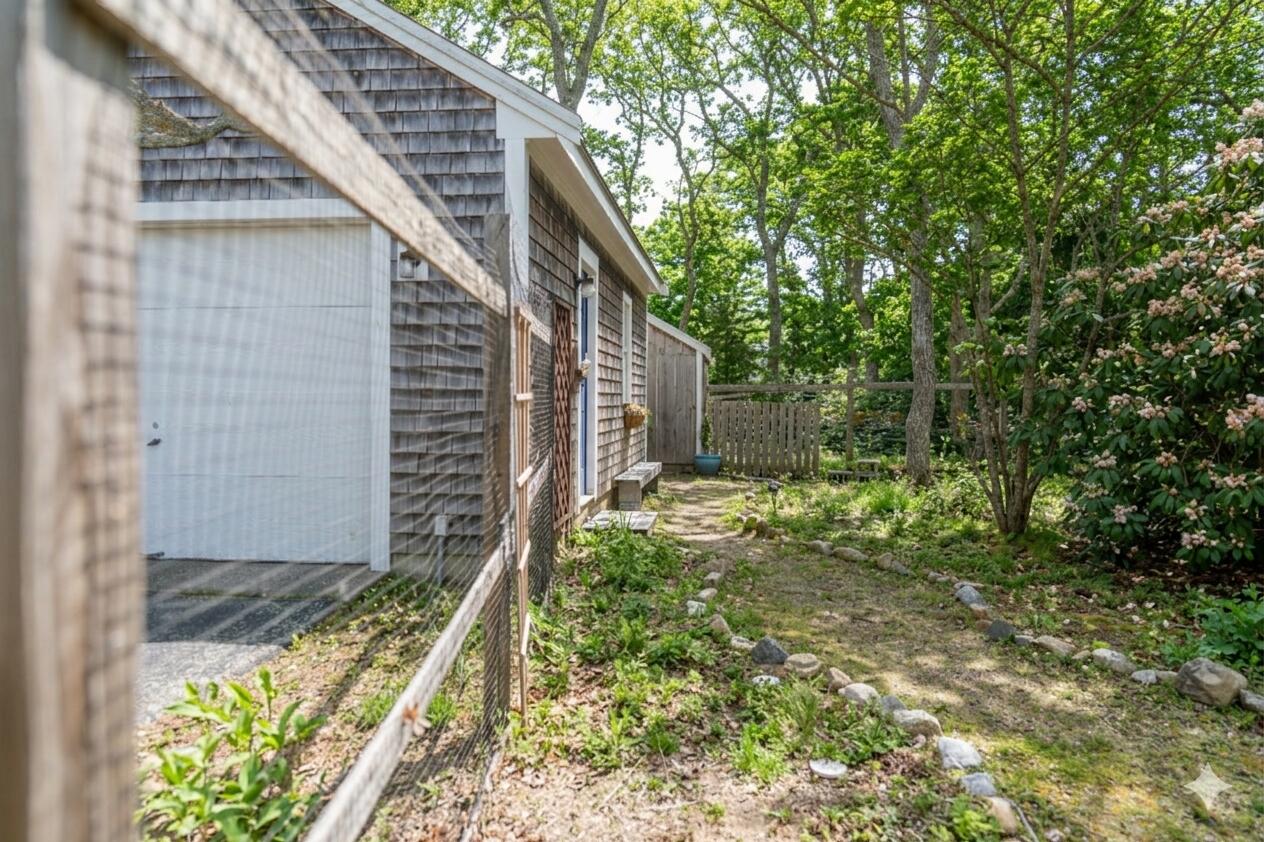 147 Brook Trail Road Brewster, MA 02631 - Photo 38 of 43 a backyard of a house with lots of green space