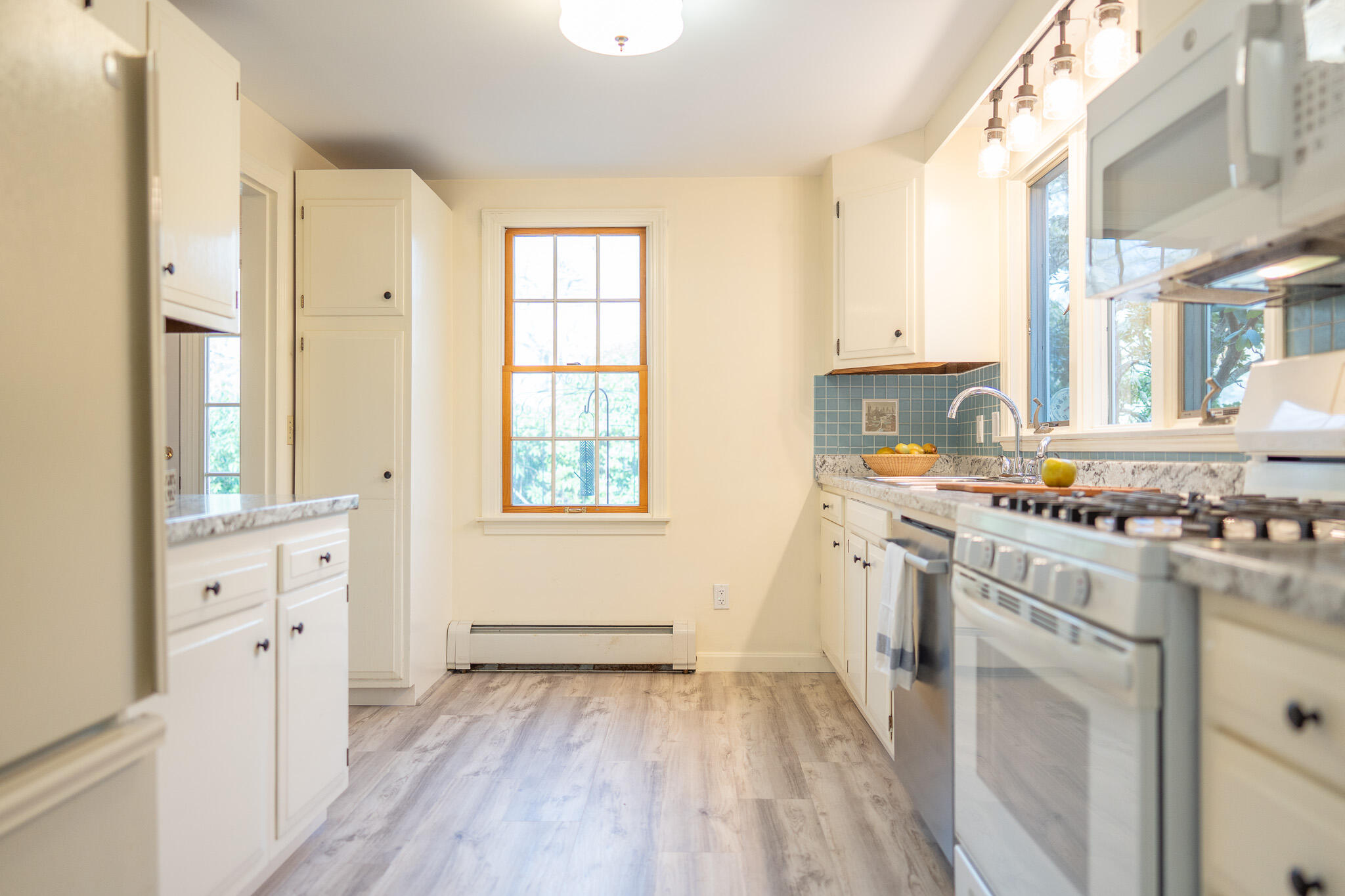 147 Brook Trail Road Brewster, MA 02631 - Photo 6 of 43 a kitchen with granite countertop a sink cabinets stainless steel appliances and a large window