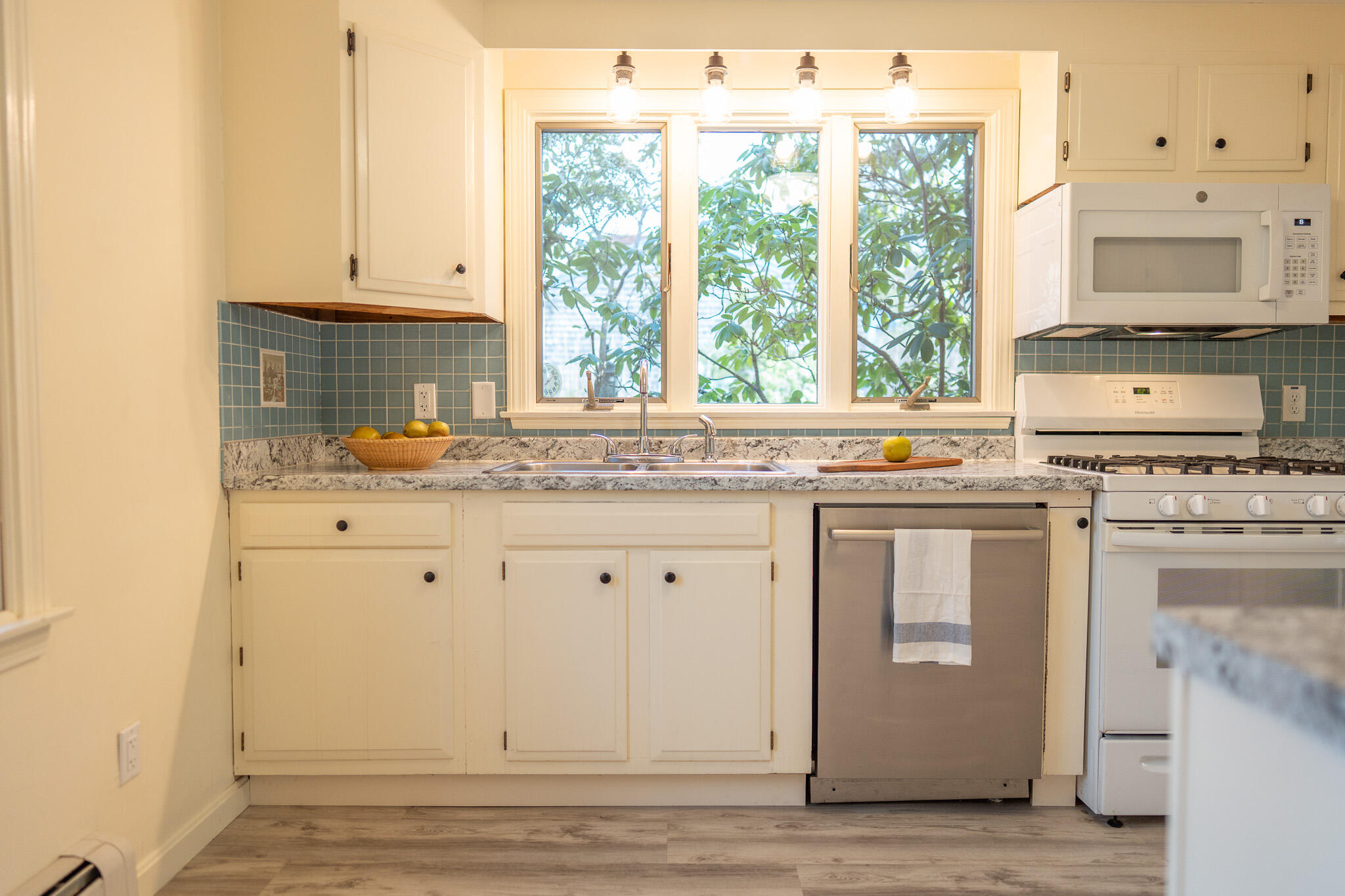 147 Brook Trail Road Brewster, MA 02631 - Photo 7 of 43 a kitchen with granite countertop white cabinets and white appliances