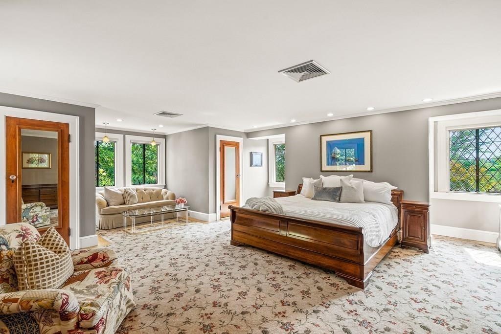 62-66 Temple Road Wellesley, MA 02482 - Photo 16 of 36 a spacious bedroom with a bed a couch and large window with outer view