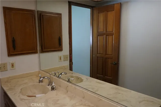 a bathroom with a sink toilet and mirror