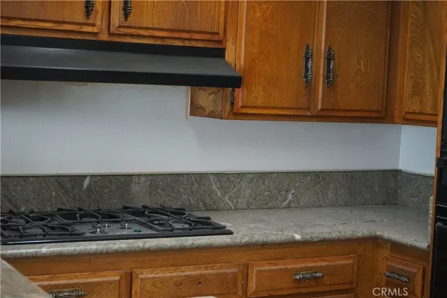 a kitchen with a stove and cabinets