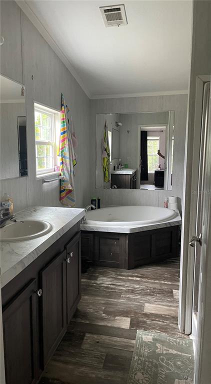 6505 Oil Well Road Clermont, FL 34714 - Photo 11 of 30 a bathroom with a double vanity sink and a mirror