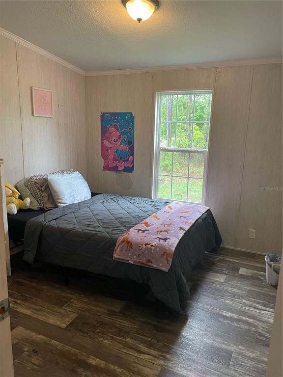 6505 Oil Well Road Clermont, FL 34714 - Photo 13 of 30 a bedroom with a bed and a window