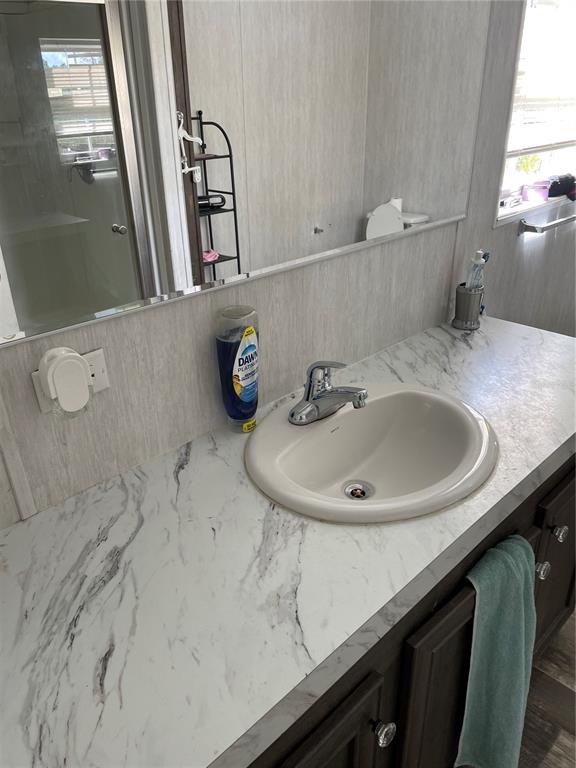 6505 Oil Well Road Clermont, FL 34714 - Photo 14 of 30 a bathroom with a sink and a mirror