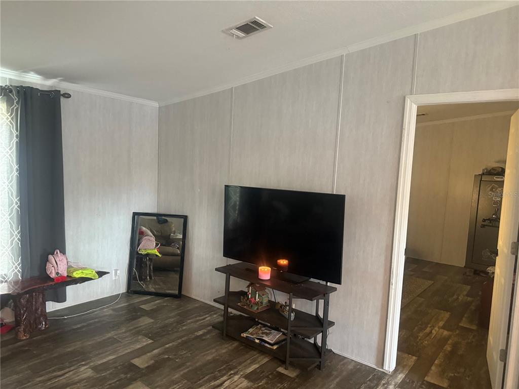 6505 Oil Well Road Clermont, FL 34714 - Photo 17 of 30 a living room with furniture and a flat screen tv
