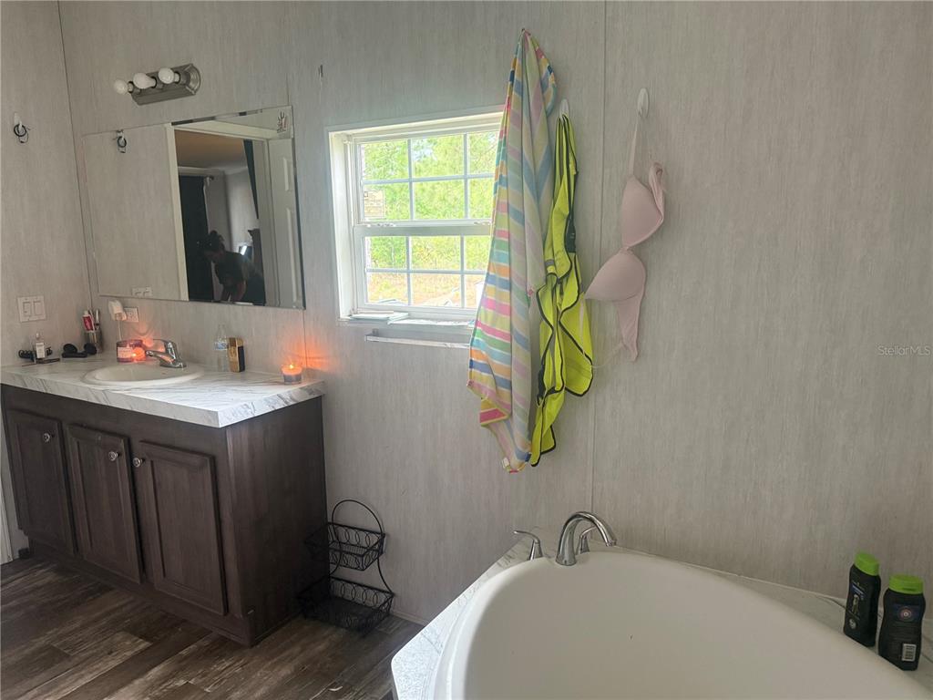 6505 Oil Well Road Clermont, FL 34714 - Photo 19 of 30 a bathroom with a sink and a mirror