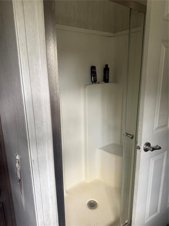 6505 Oil Well Road Clermont, FL 34714 - Photo 20 of 30 a bathroom with a glass shower door