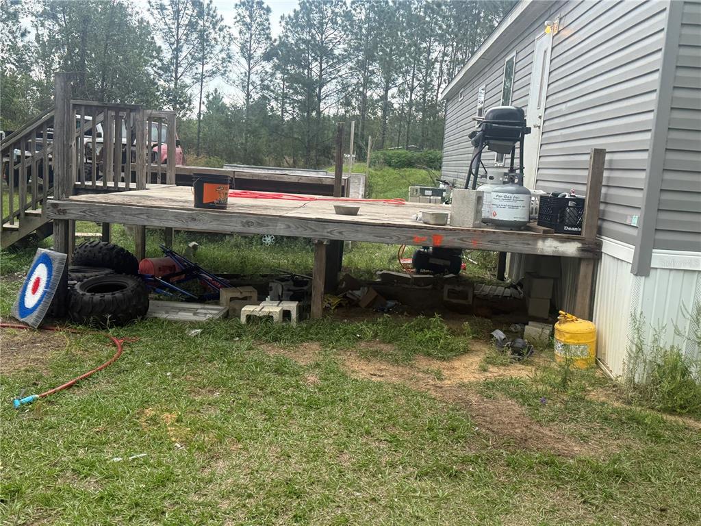 6505 Oil Well Road Clermont, FL 34714 - Photo 24 of 30 a backyard of a house with yard and outdoor seating