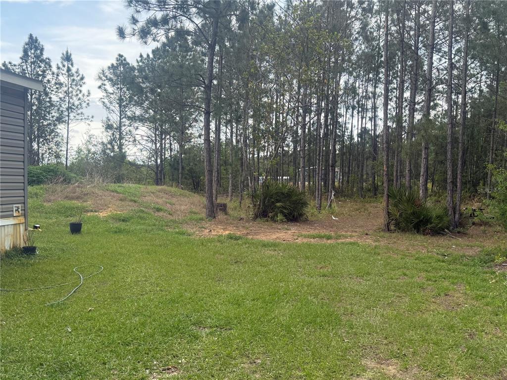6505 Oil Well Road Clermont, FL 34714 - Photo 28 of 30 a view of outdoor space with deck and yard