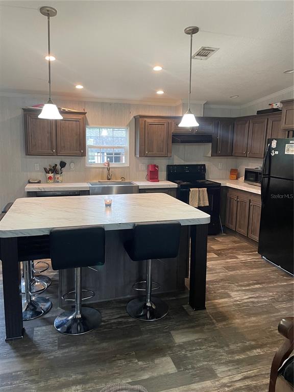 6505 Oil Well Road Clermont, FL 34714 - Photo 3 of 30 a kitchen with a dining table chairs sink and stove