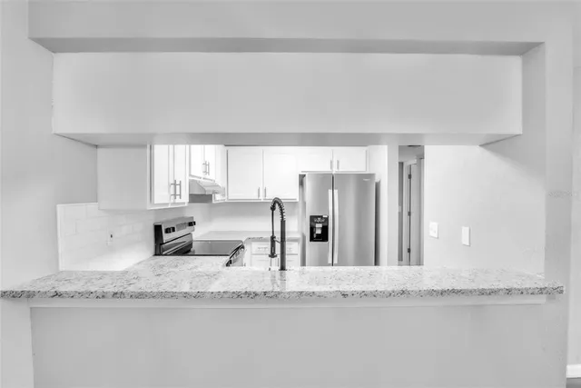 a bathroom with granite countertop a mirror and a sink