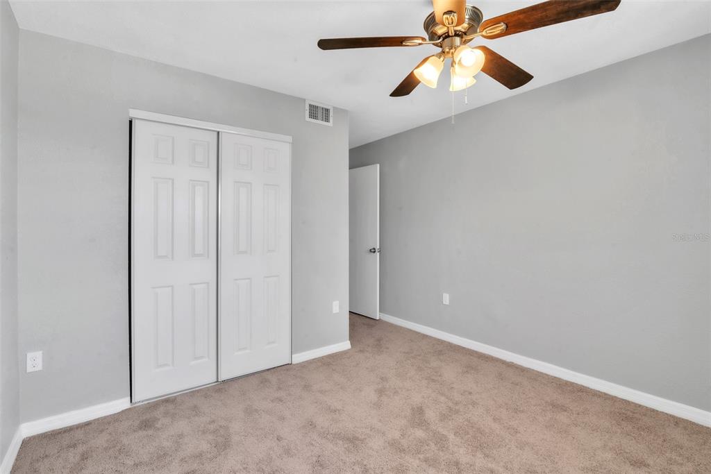 3281 South Beneva Road, Unit 202 Sarasota, FL 34232 - Photo 13 of 26 an empty room with closet and a chandelier fan