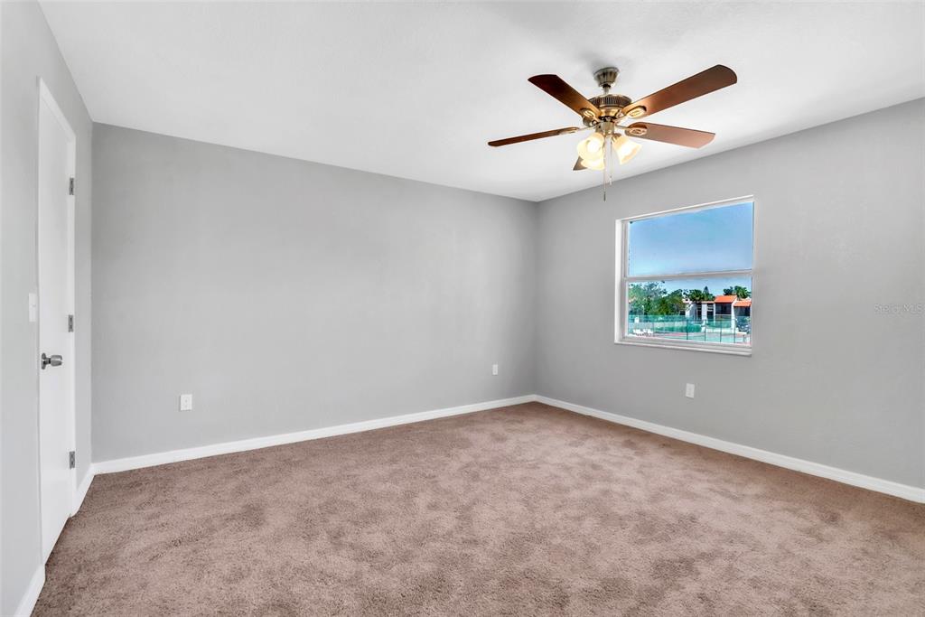 3281 South Beneva Road, Unit 202 Sarasota, FL 34232 - Photo 14 of 26 an empty room with window and ceiling fan