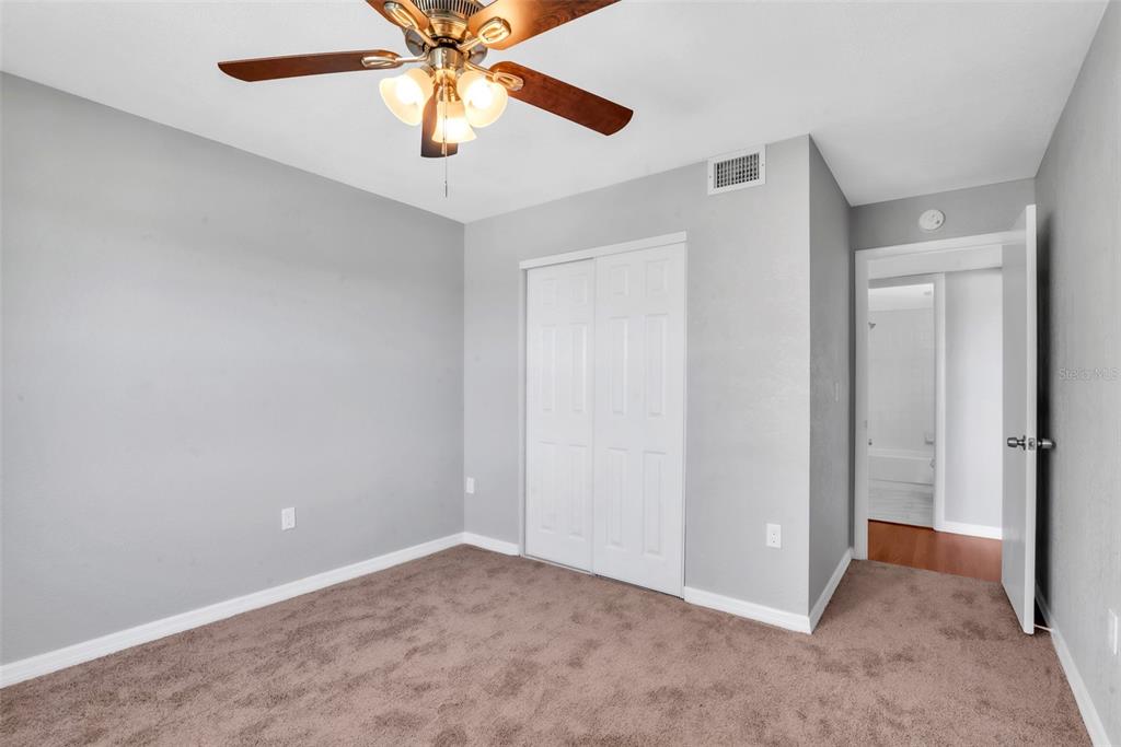 3281 South Beneva Road, Unit 202 Sarasota, FL 34232 - Photo 15 of 26 an empty room with closet and a chandelier fan
