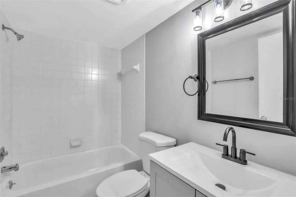 3281 South Beneva Road, Unit 202 Sarasota, FL 34232 - Photo 18 of 26 a bathroom with a sink toilet and shower