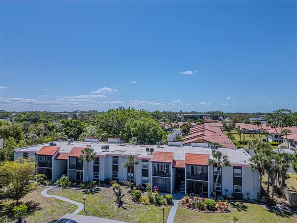a view of a house with swimming pool and sitting area