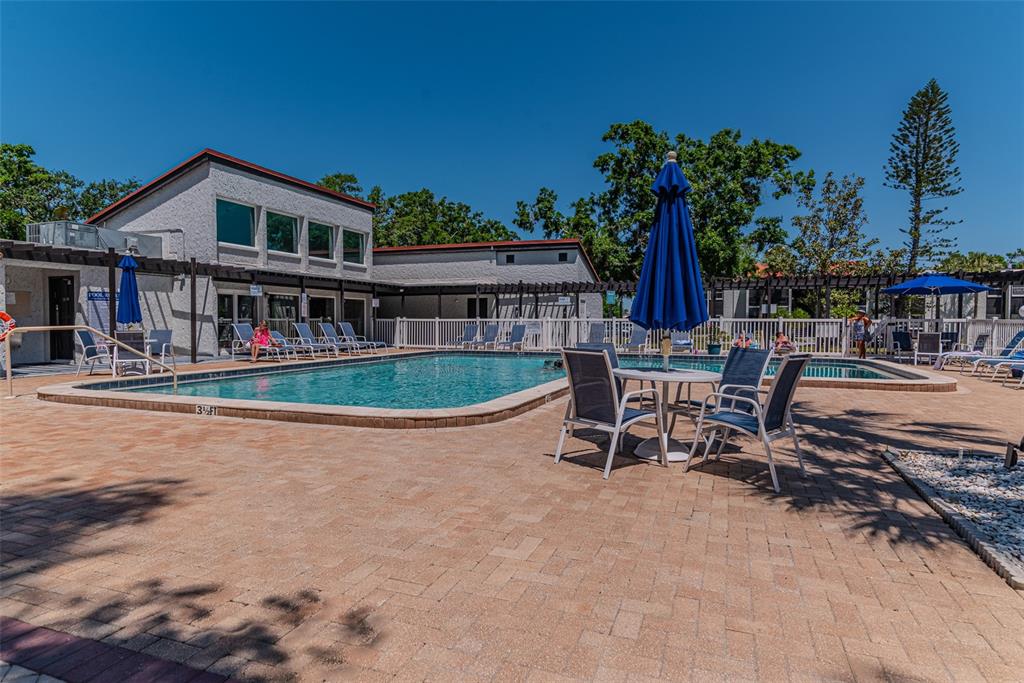 3281 South Beneva Road, Unit 202 Sarasota, FL 34232 - Photo 23 of 26 a view of a house with swimming pool and sitting area