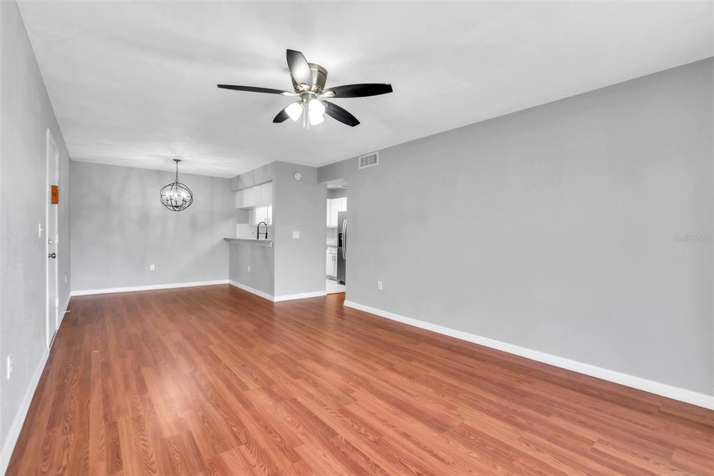 3281 South Beneva Road, Unit 202 Sarasota, FL 34232 - Photo 3 of 26 a view of empty room with wooden floor and fan