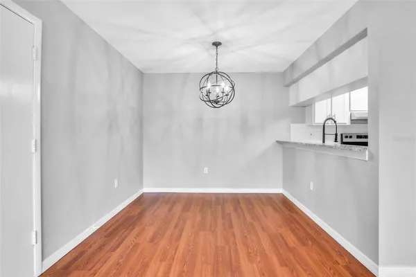 a view of a room with wooden floor and a window