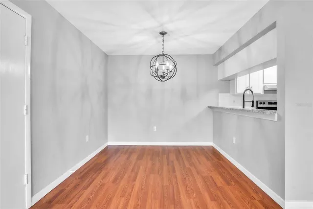 a view of a room with wooden floor and a window