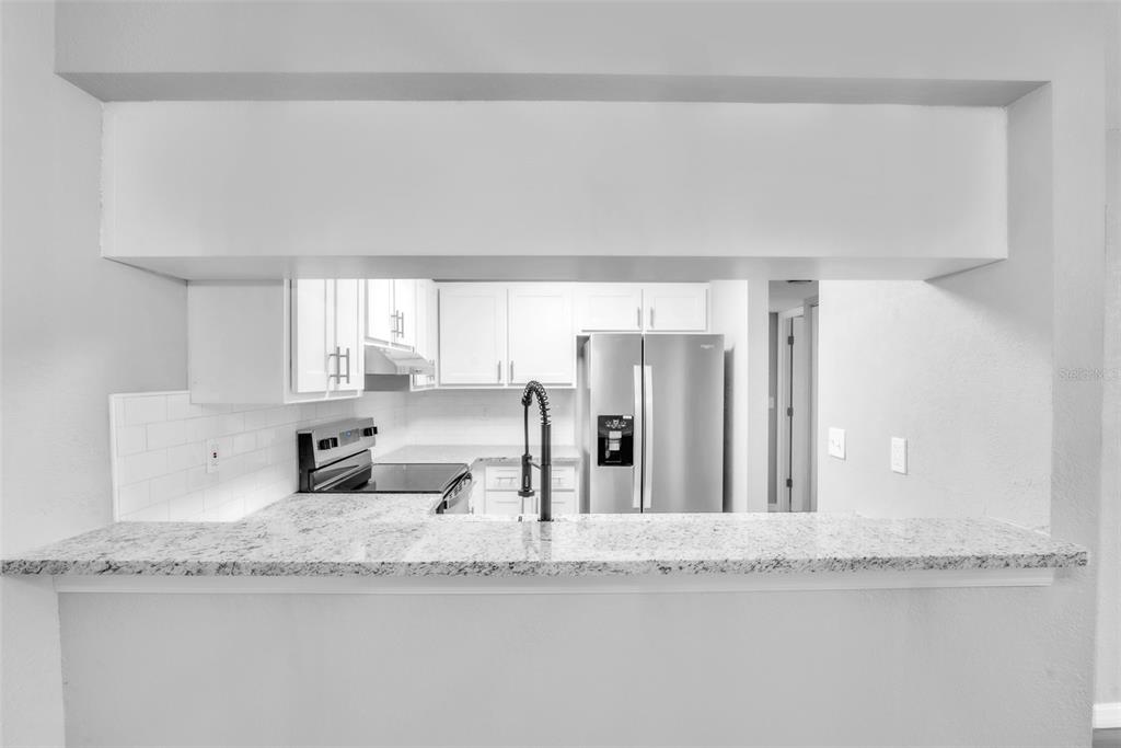 3281 South Beneva Road, Unit 202 Sarasota, FL 34232 - Photo 10 of 26 a bathroom with granite countertop a mirror and a sink