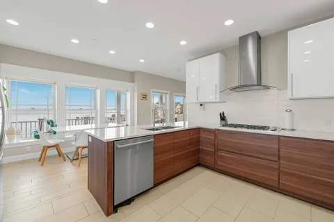a kitchen with stainless steel appliances granite countertop a sink and cabinets