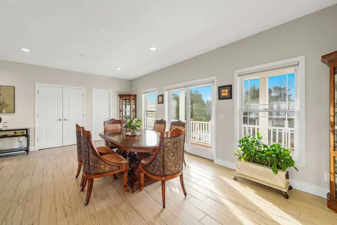 a view of a dining room with furniture window and wooden floor